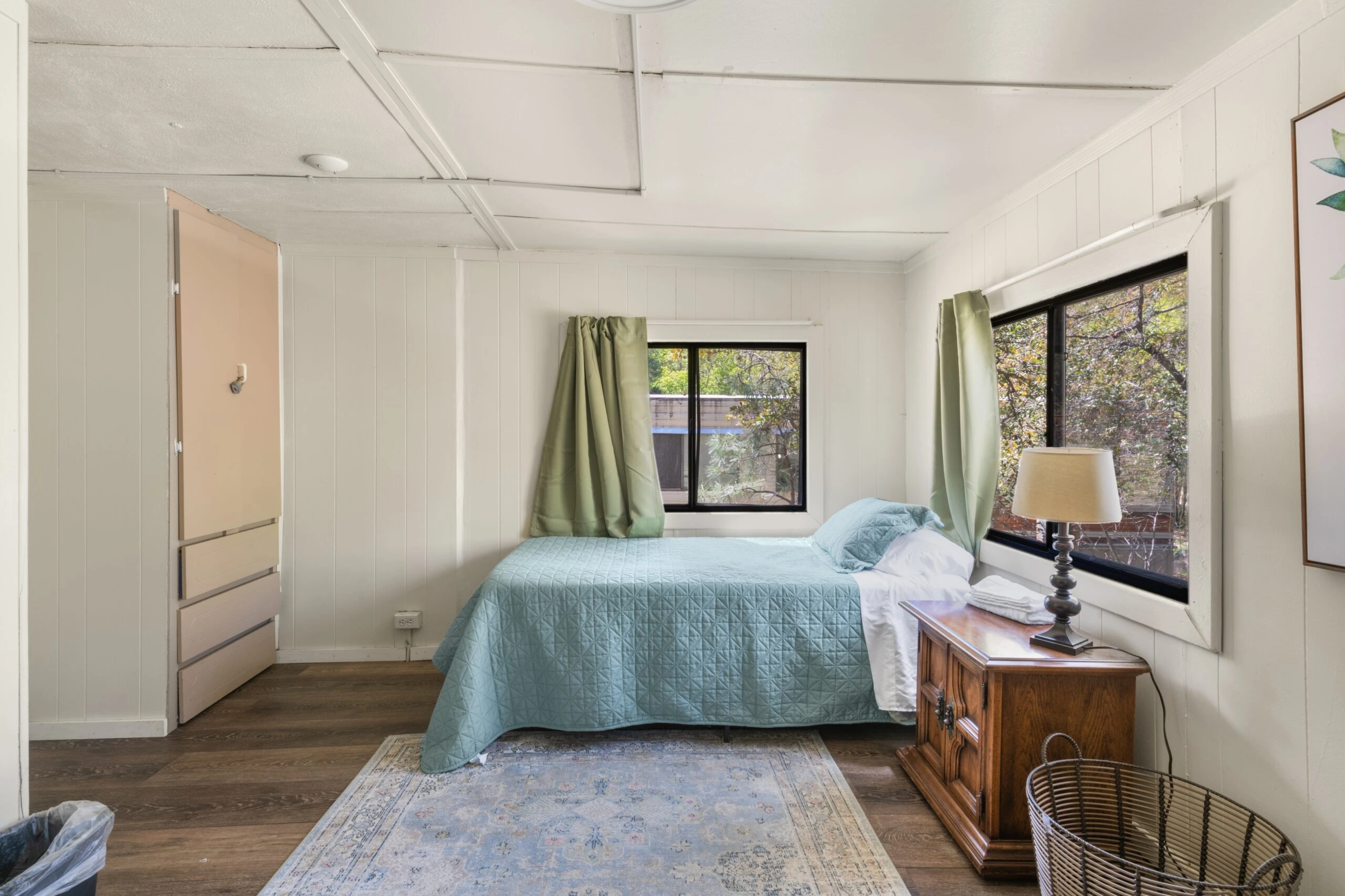 a bedroom with a bed and a dresser