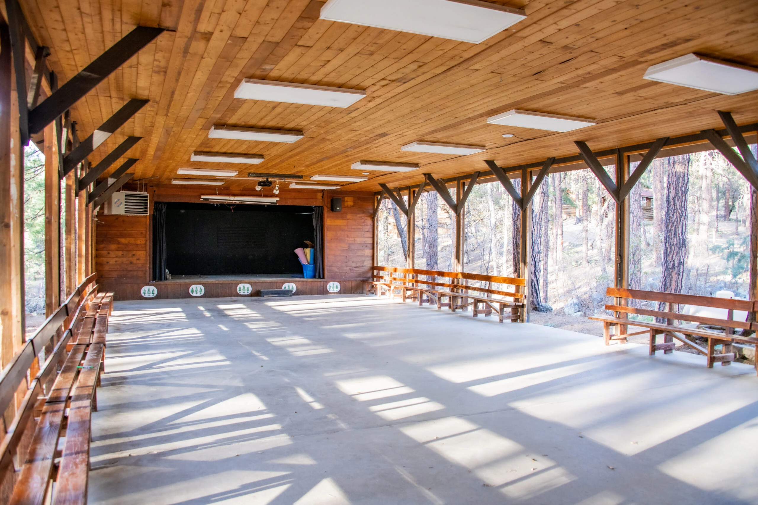 a large room with benches and a stage