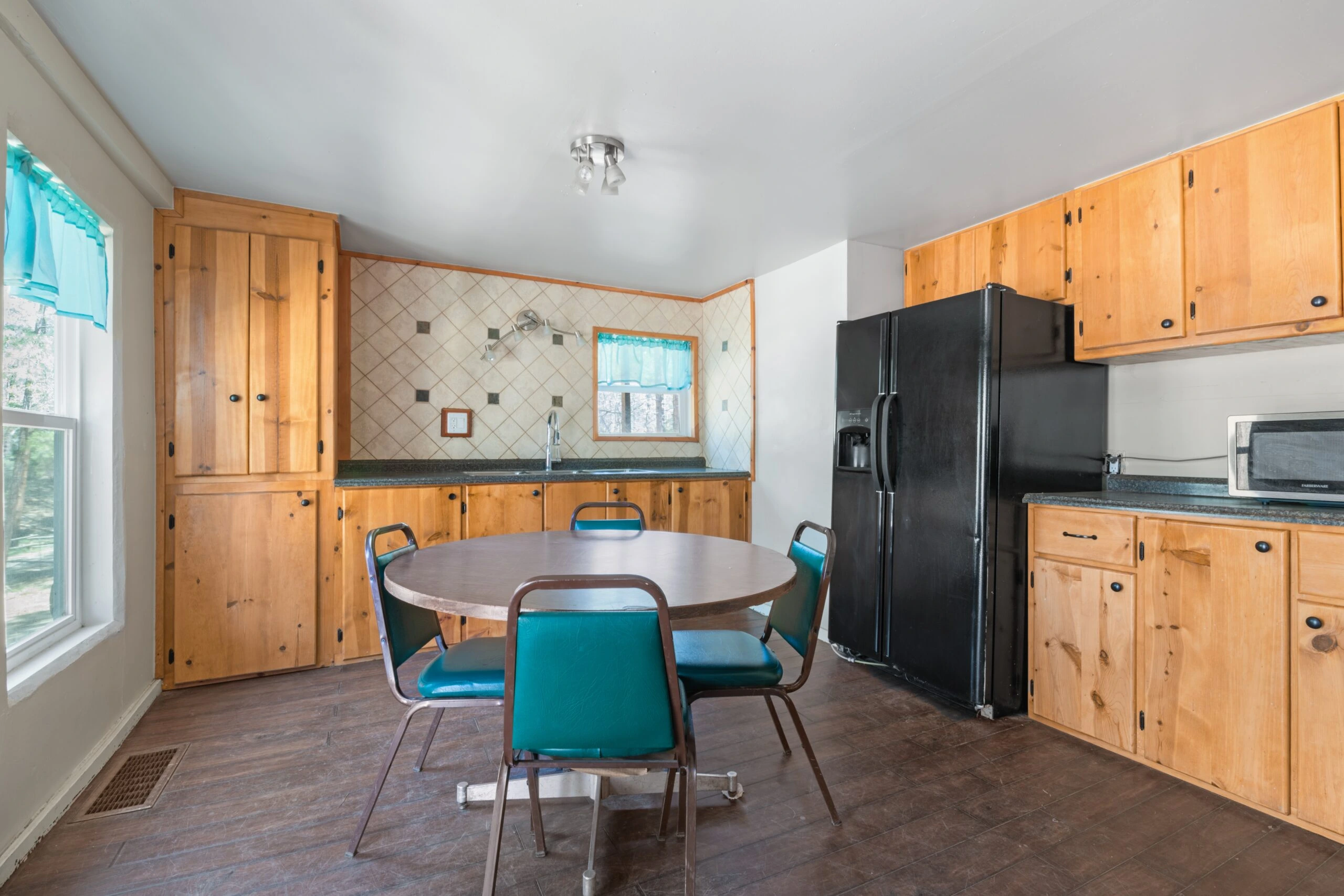 a kitchen with a table and chairs