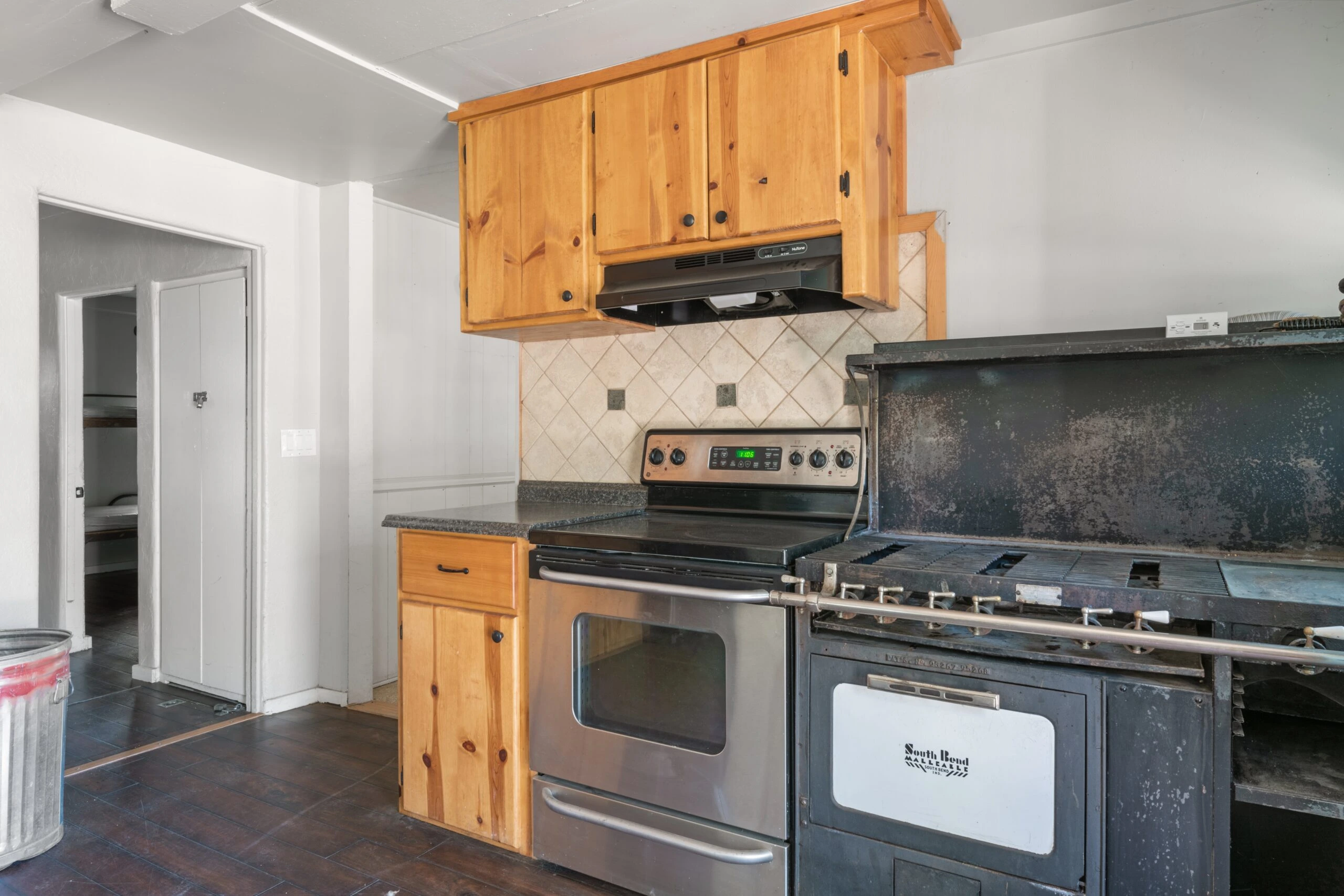 a kitchen with wood cabinets and a stove