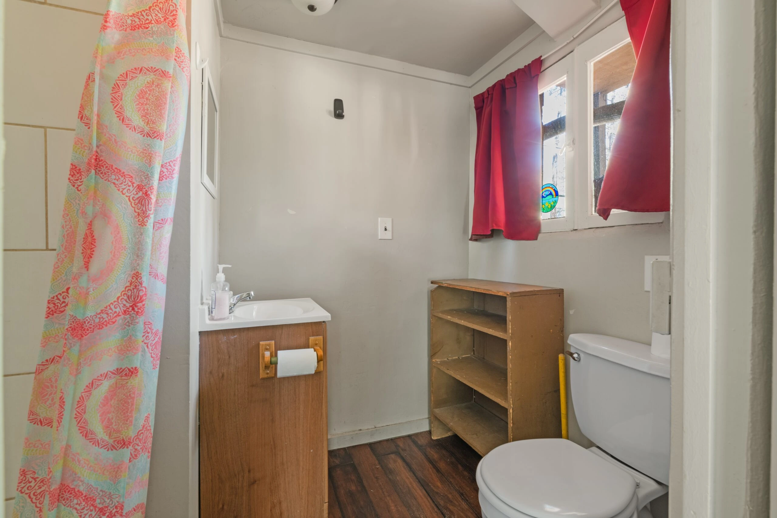 a bathroom with a toilet and a shelf
