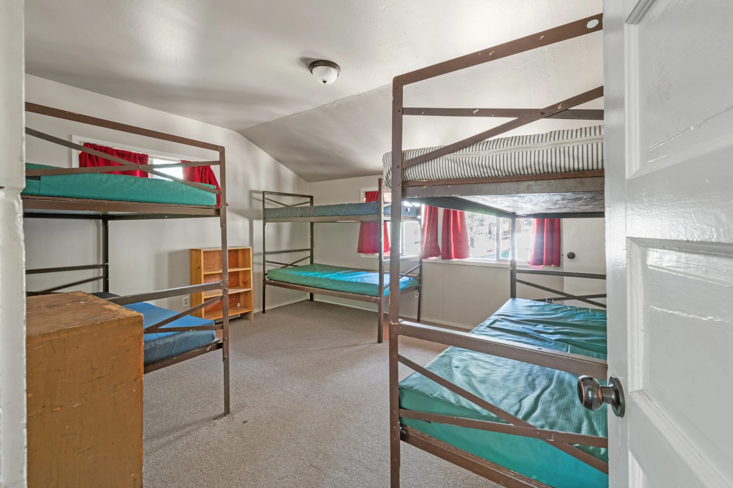a room with bunk beds and a door