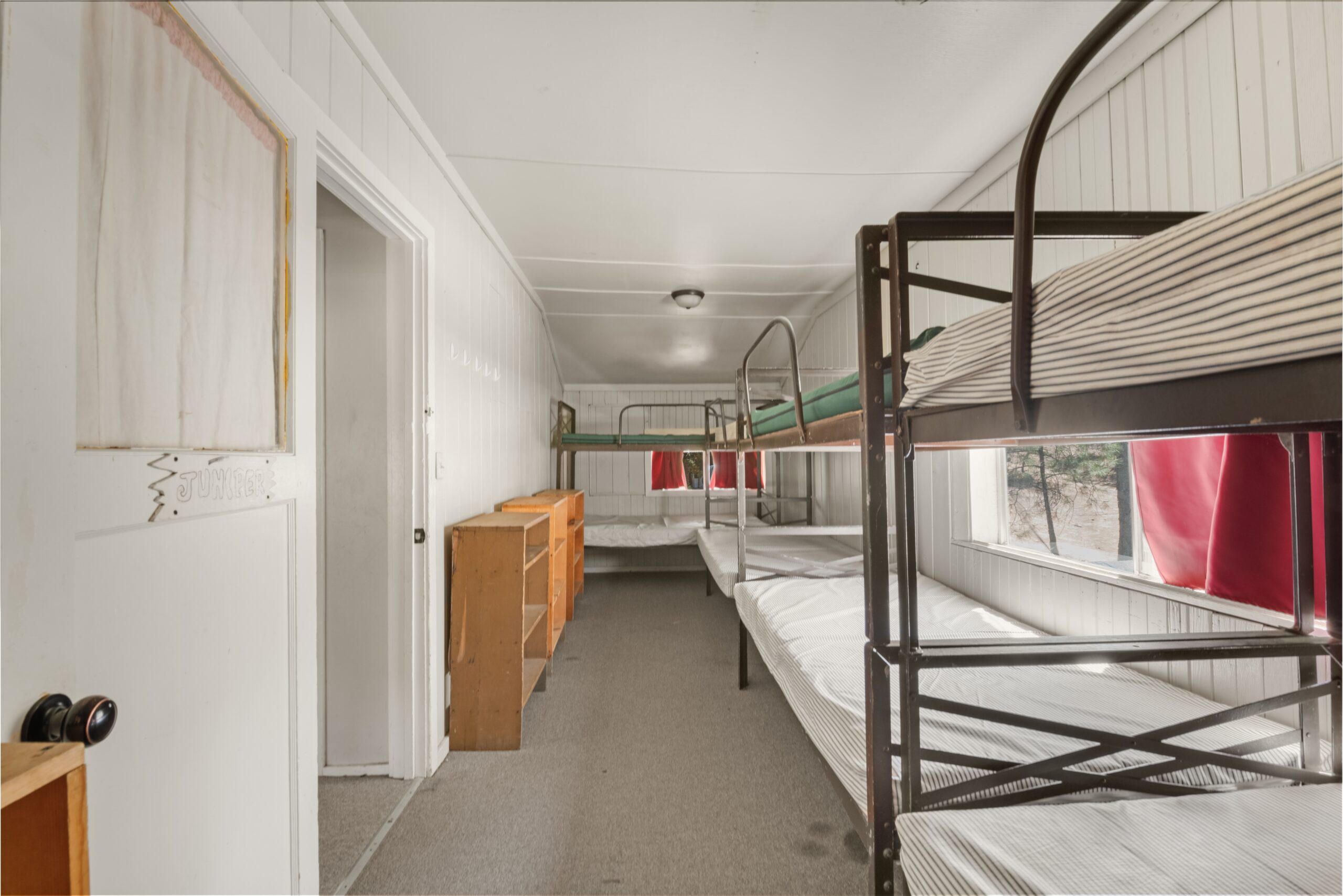 a room with bunk beds and a window