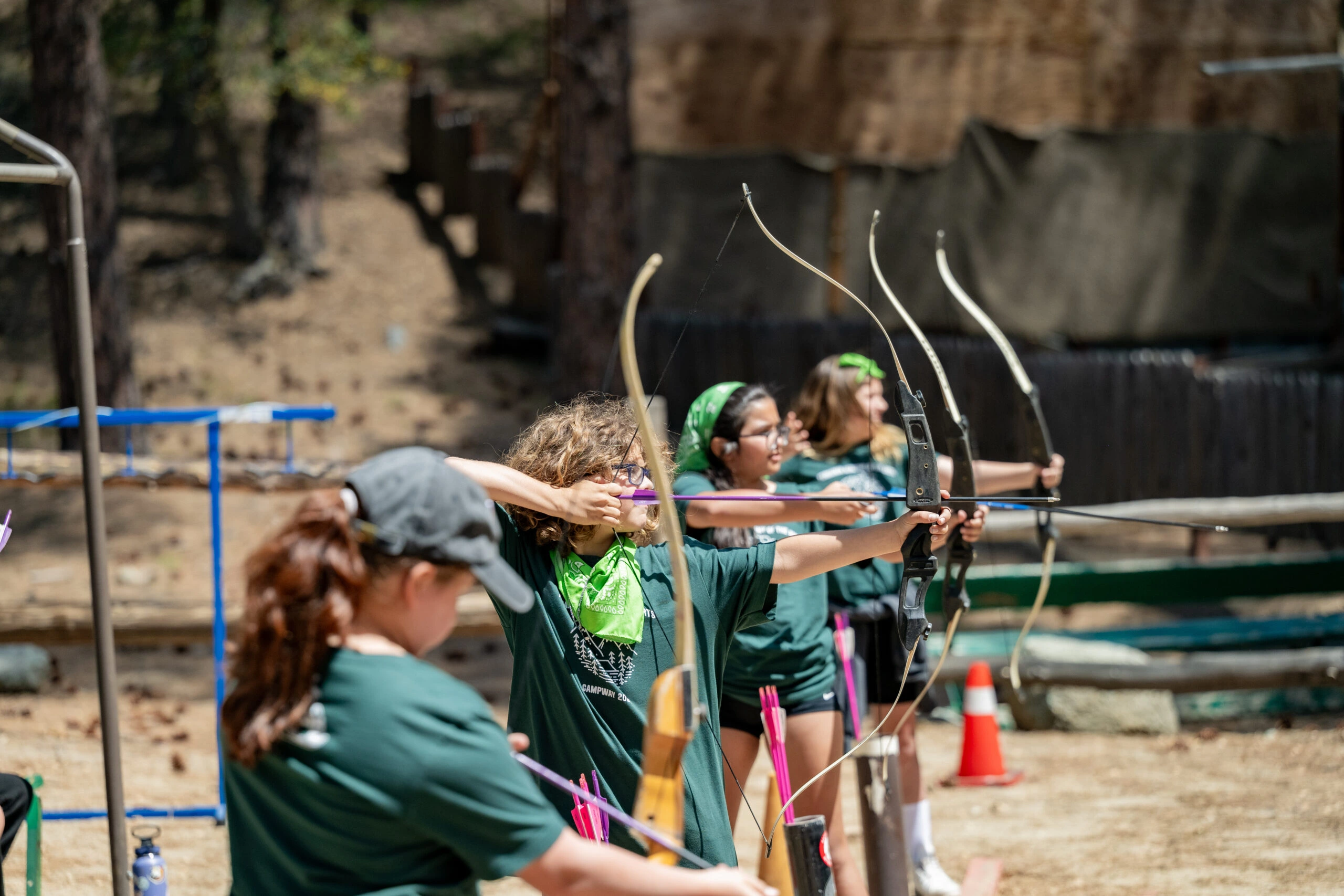 a group of people shooting bows and arrows