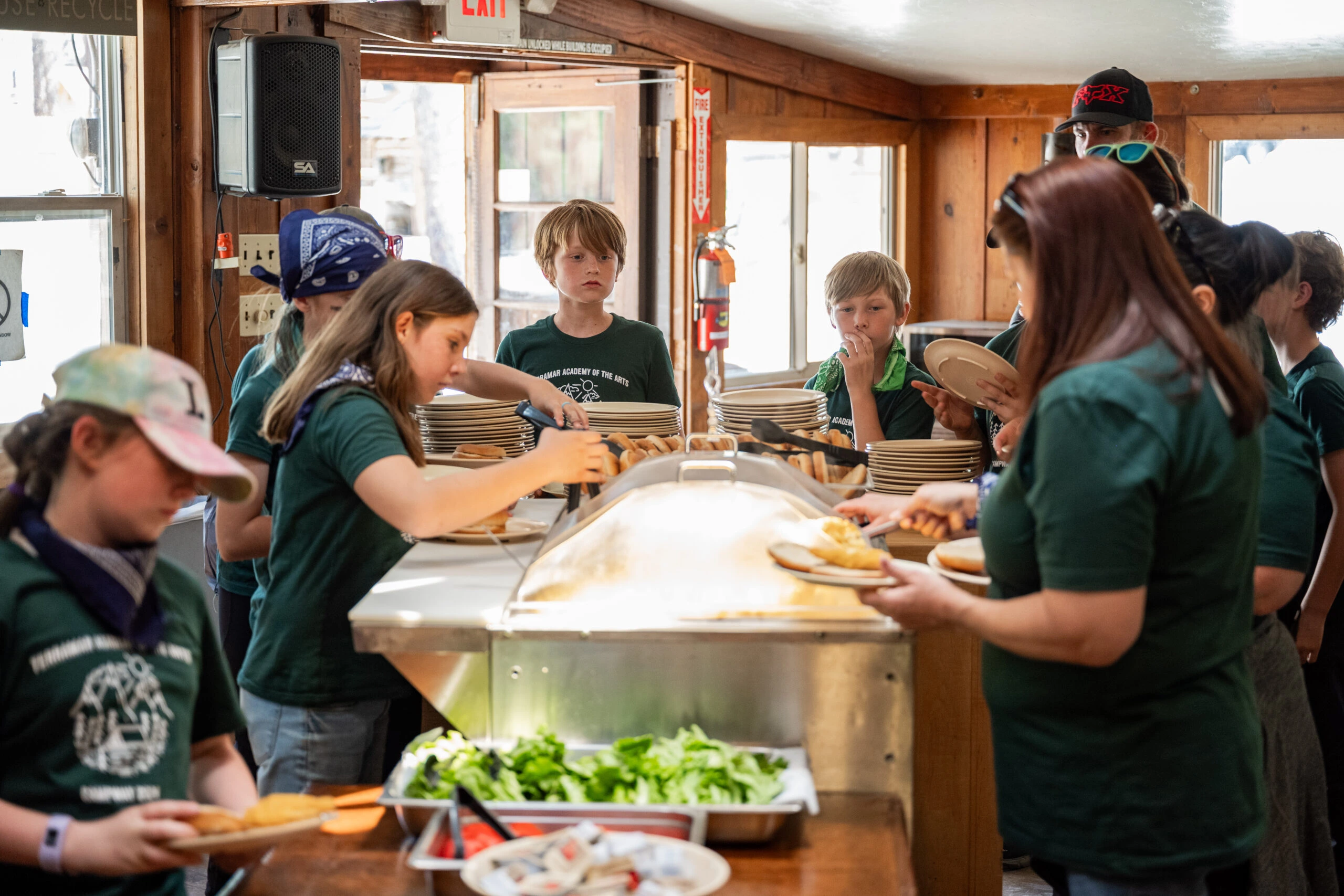 a group of people in green shirts