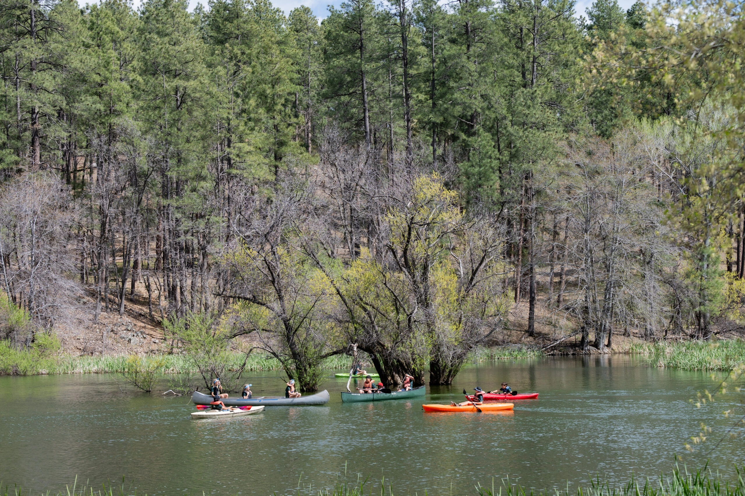 a group of people in canoes on a lake
