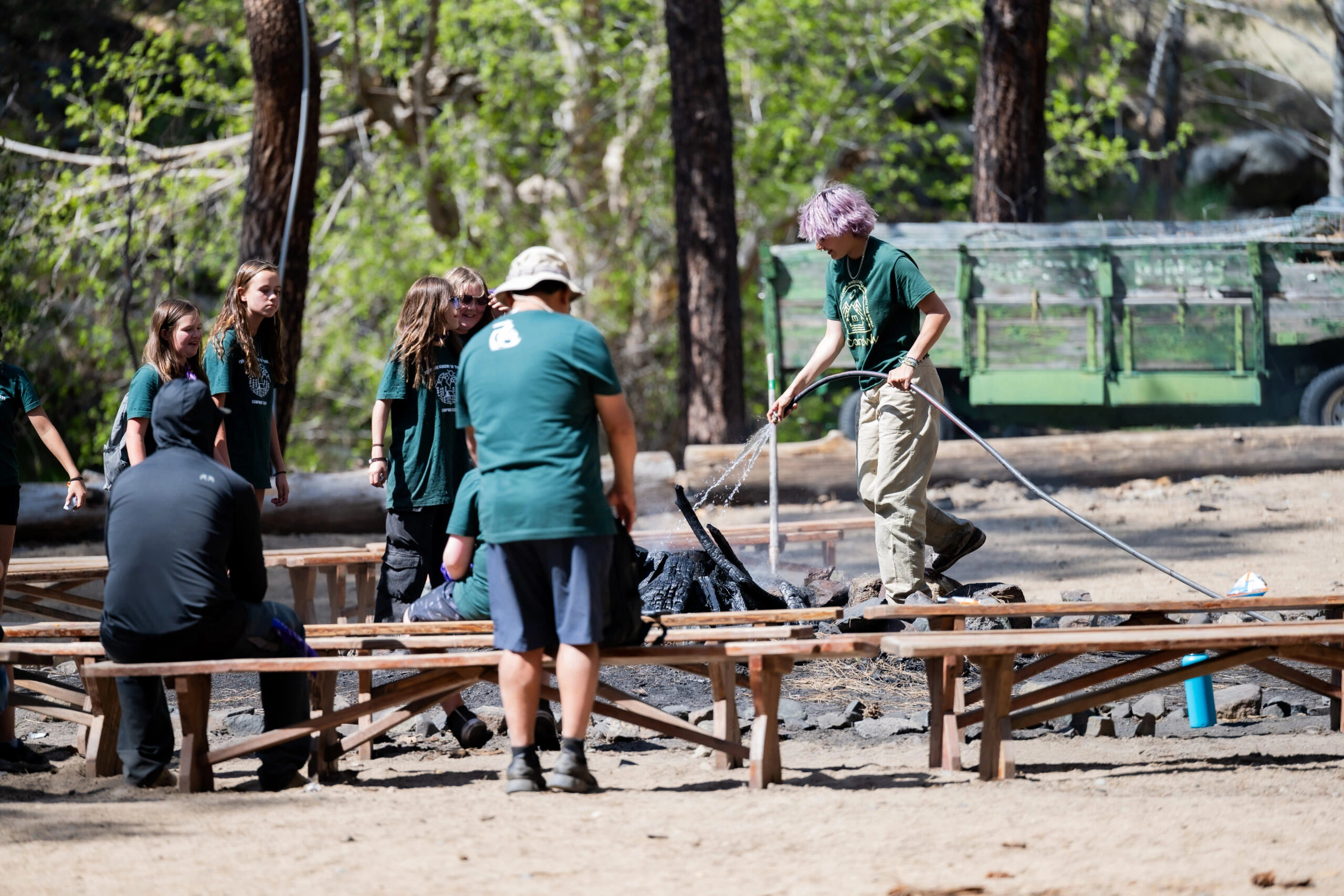 a group of people around a fire pit