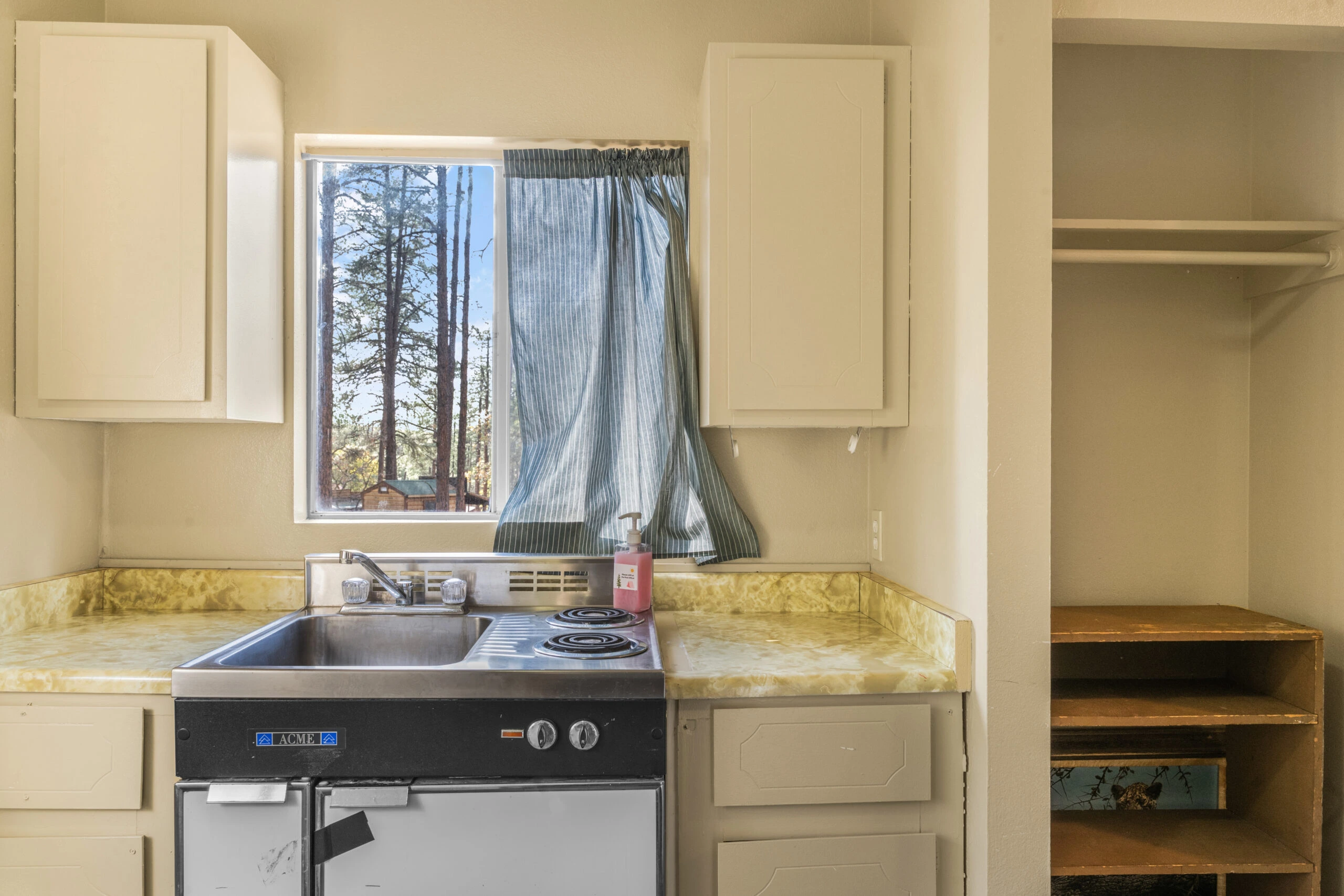 a kitchen with a sink and cupboards