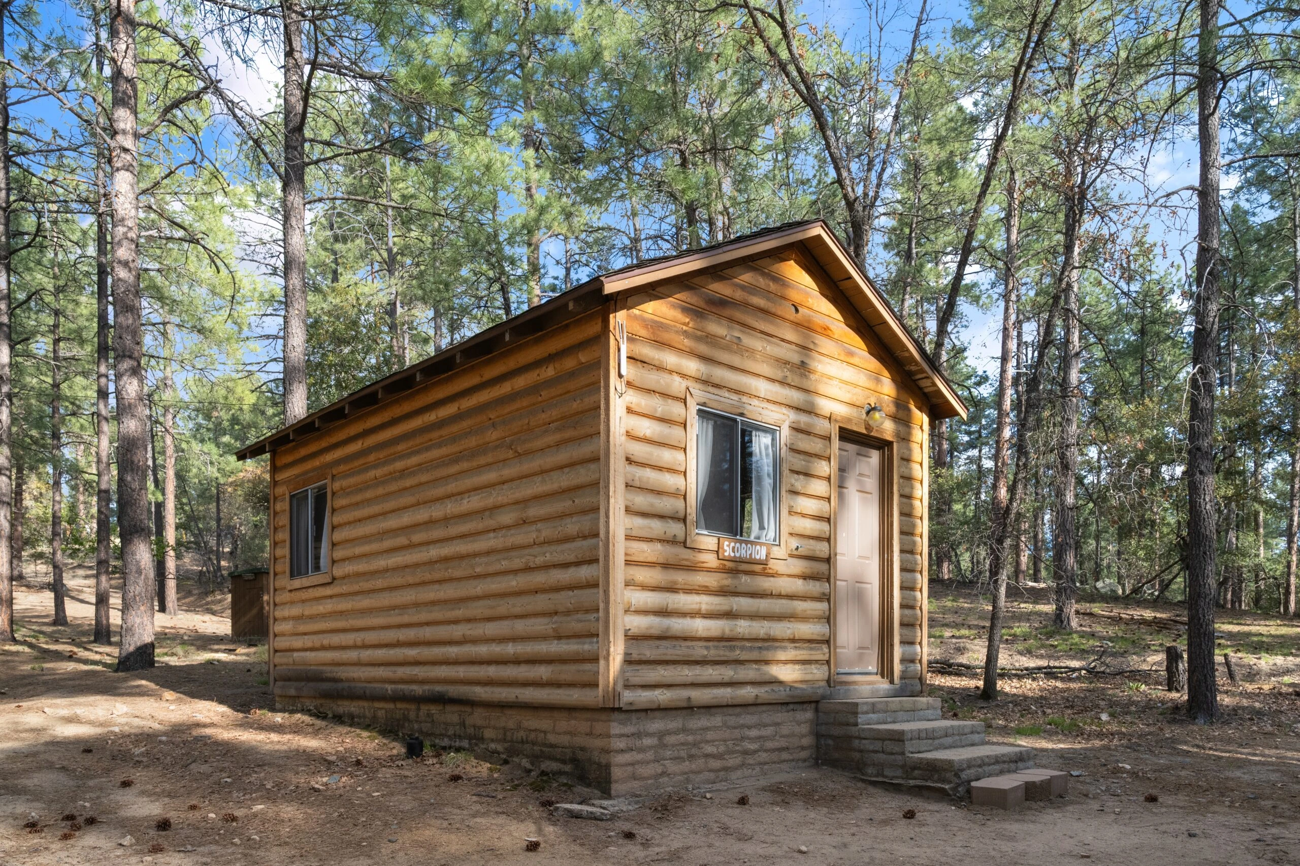 a small log cabin in the woods