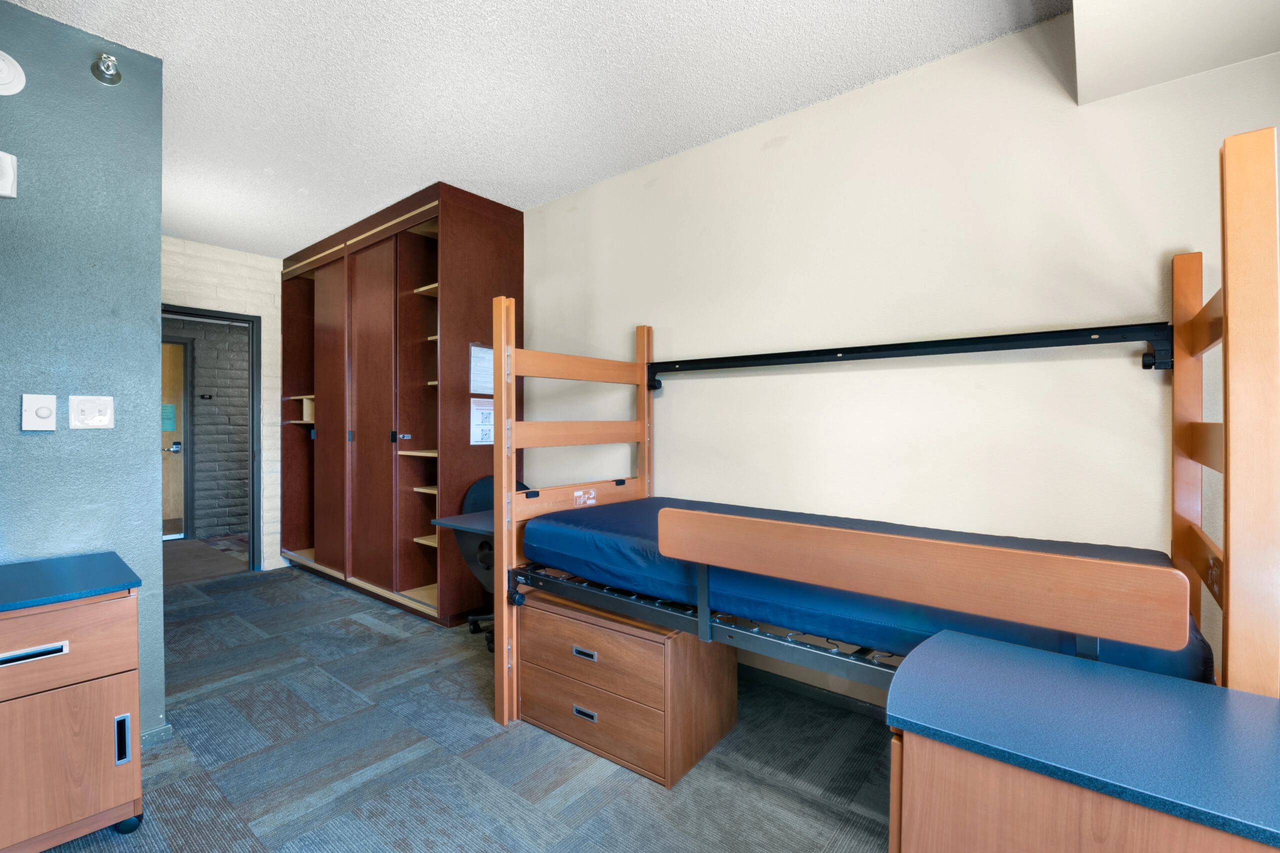a room with a bed and a cabinet