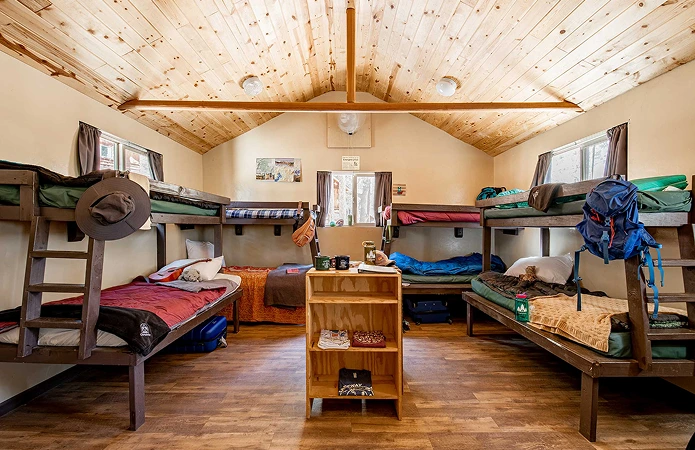 a room with bunk beds and a wood floor
