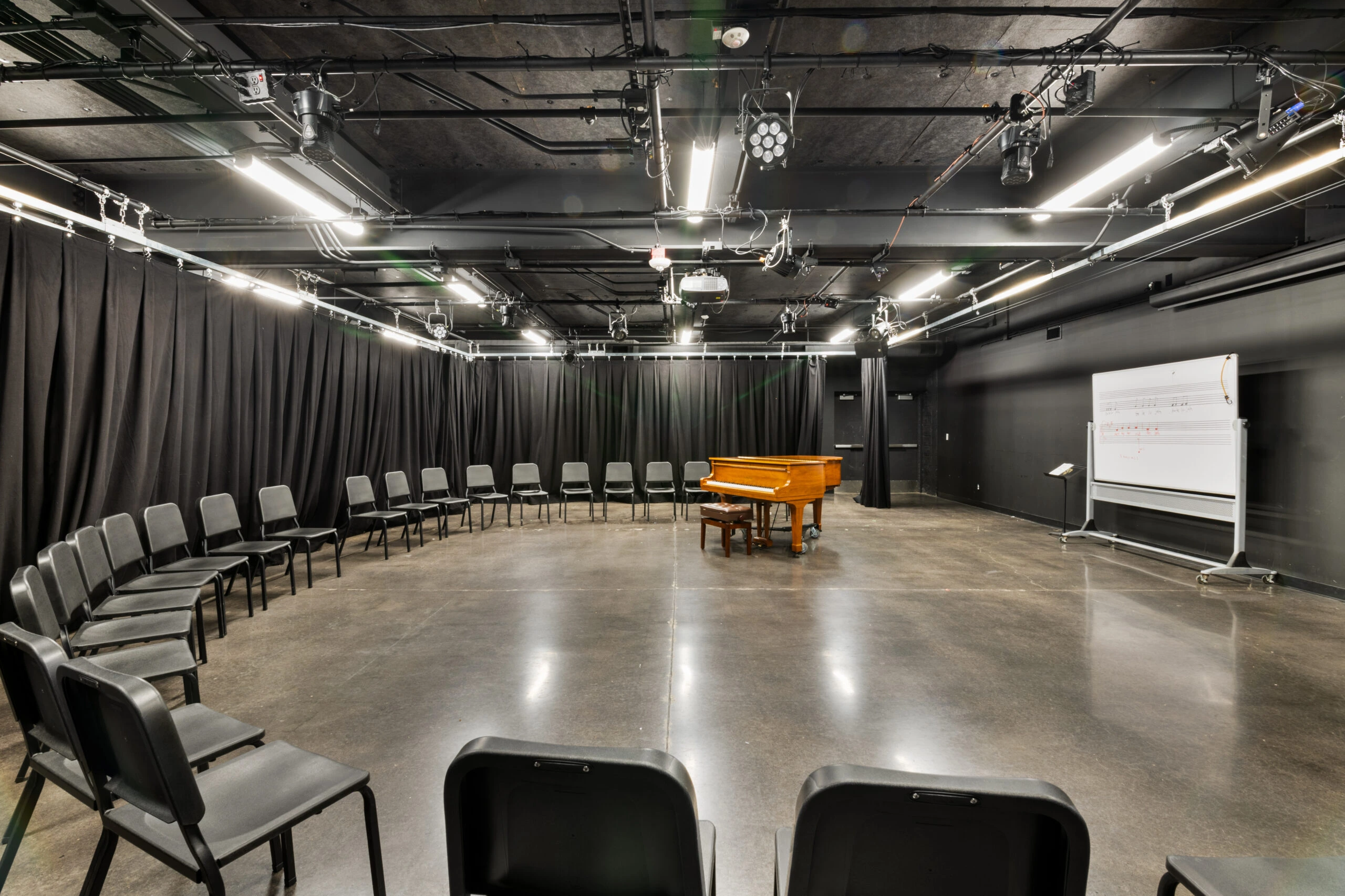 a piano in a room with chairs