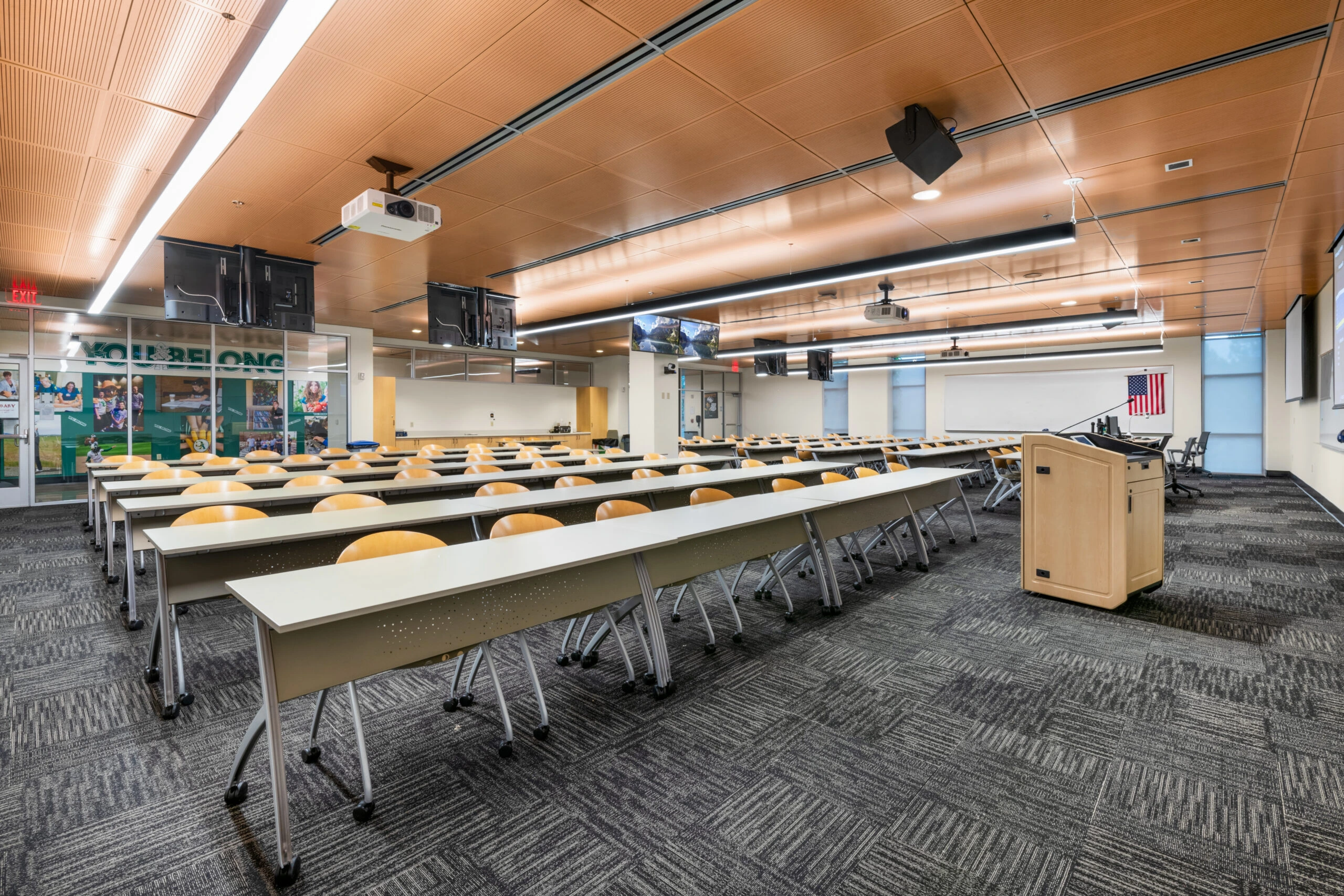 a room with rows of tables and chairs