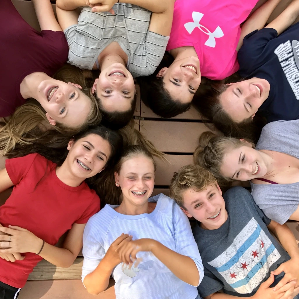 a group of people lying down on a wood surface