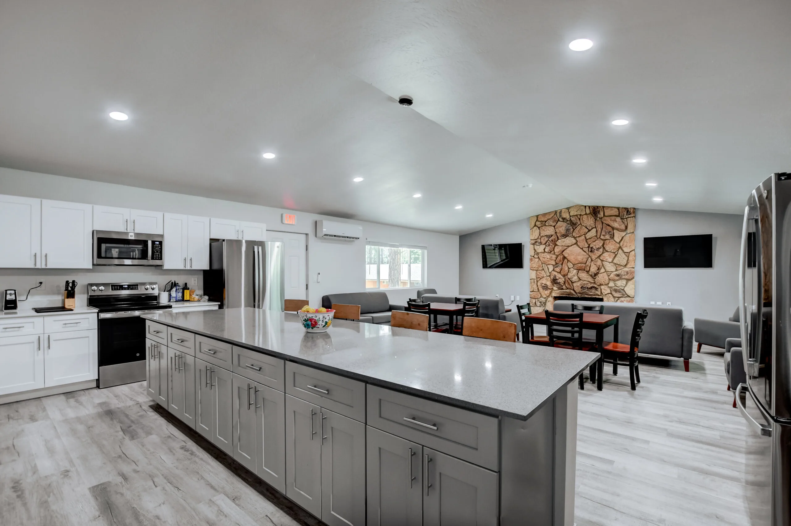 a large kitchen with a large island and a large refrigerator