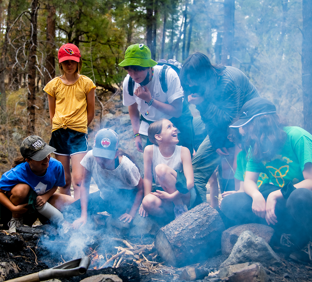 a group of people around a fire