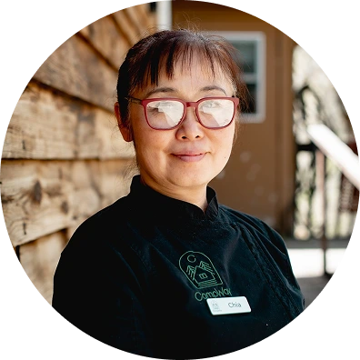 a woman wearing glasses and a black shirt