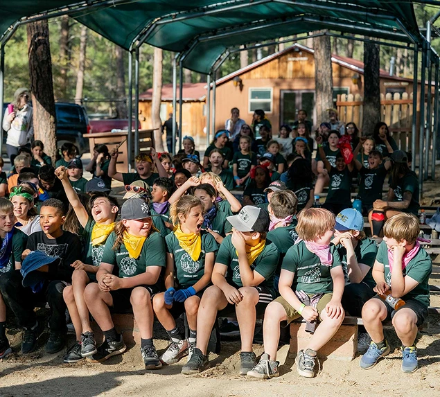 a group of kids sitting on a bench