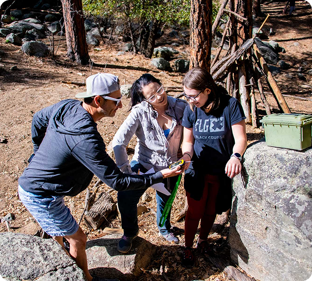 a group of people standing on rocks