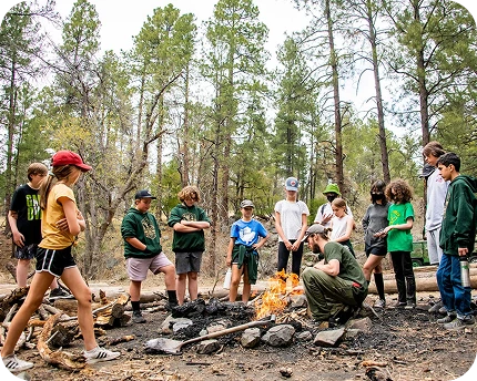 a group of people around a fire